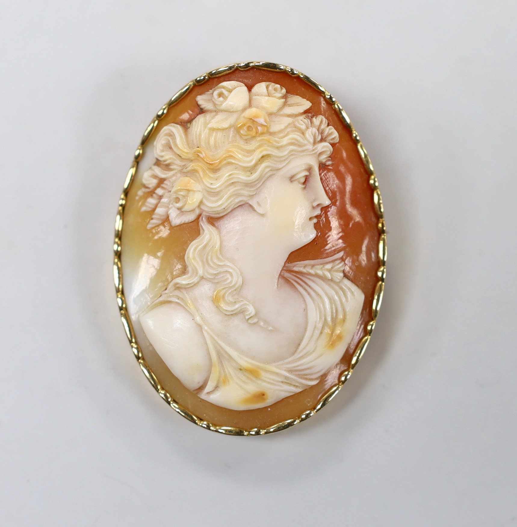 A Swedish 18k mounted oval cameo shell brooch, carved with the bust of a lady to sinister, 51mm.
